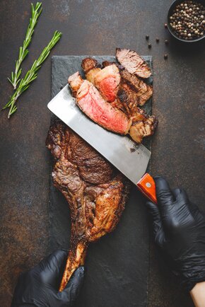 photodune-23925084-man-in-black-gloves-cuts-dryaged-marble-beef-steak-tomahawk-top-view-dinner-concept.jpg